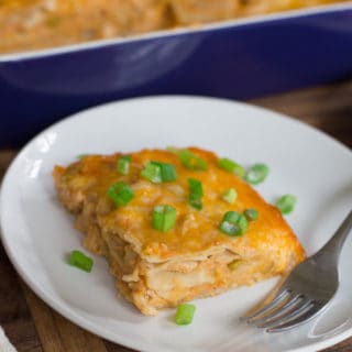 Creamy Chicken Enchilada Casserole - One Piece Served in a White Plate with a Fork on the Side