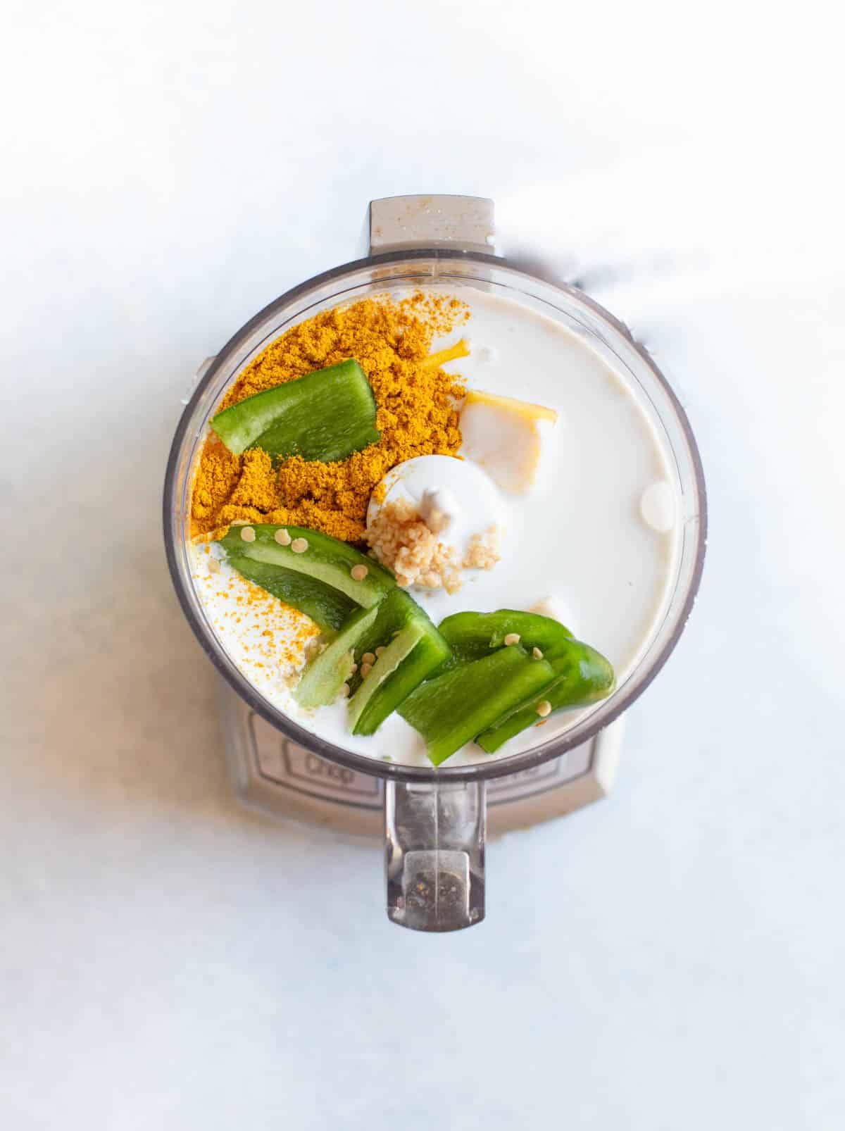 Food processor with mango curry marinade in it.