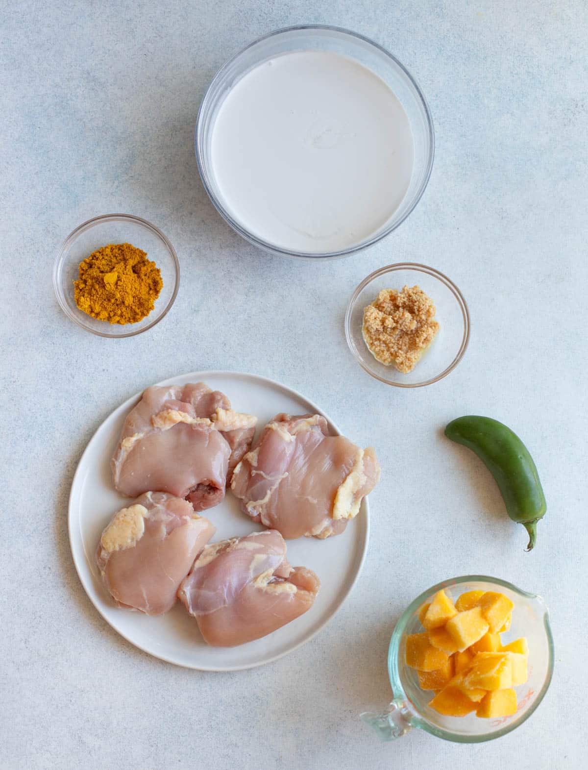 Ingredients in Grilled Mango Chicken on a gray background.
