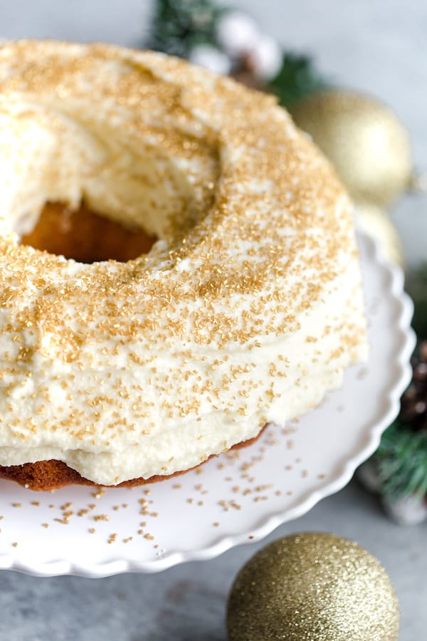 Boozy Eggnog Bundt Cake on a white plate with a toy next to it