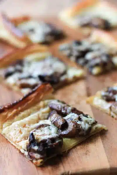 Mushroom Havarti Flatbread on the Wooden Board Cut in Square Bites