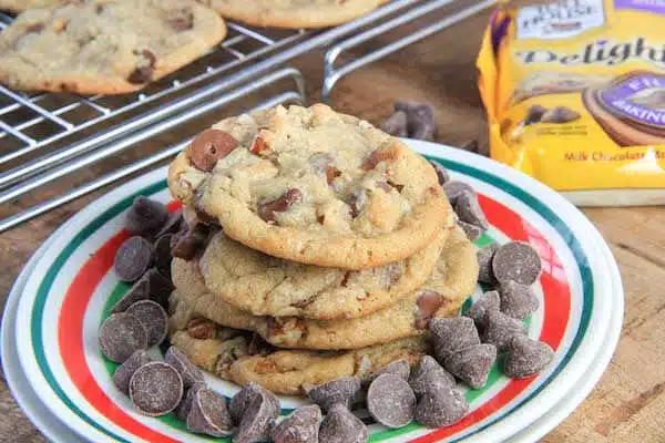 Brown Butter Chocolate Caramel Pecan Cookies served with chocolate chips inside the plate and more cookies outside of it