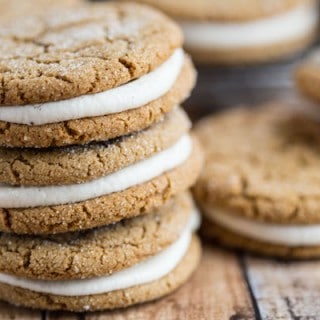 Fantastic Ginger Molasses Sandwich Cookies with Eggnog Buttercream stacked in a yummy tower of three