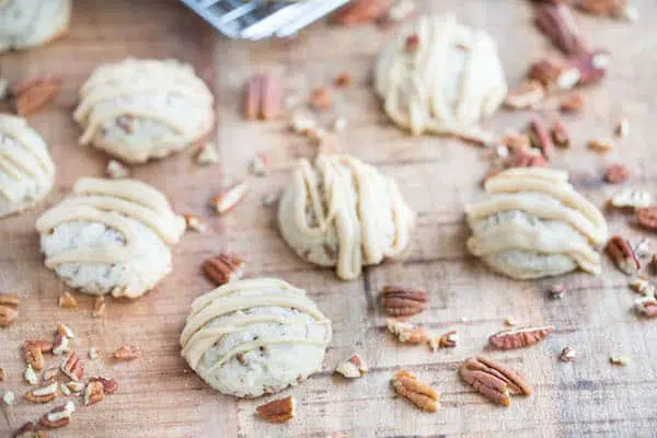 Butter Pecan Maple Cookies served on the table with lots of pecans around the cookies
