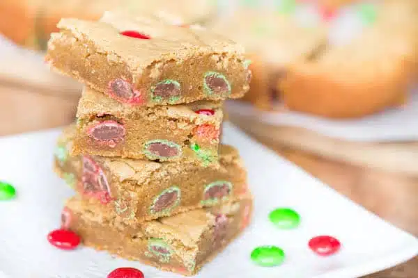 Peanut Butter M&M Blondies served in a tower with green and red candies around