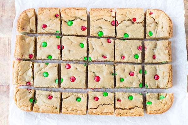 Peanut Butter M&M Blondies straight out of the oven cut into squares and ready to be served