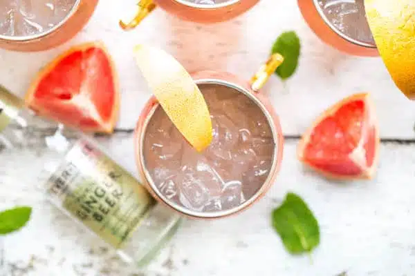 Grapefruit Moscow Mules - Overhead with a Ginger Beer Bottle and Grapefruit Pieces