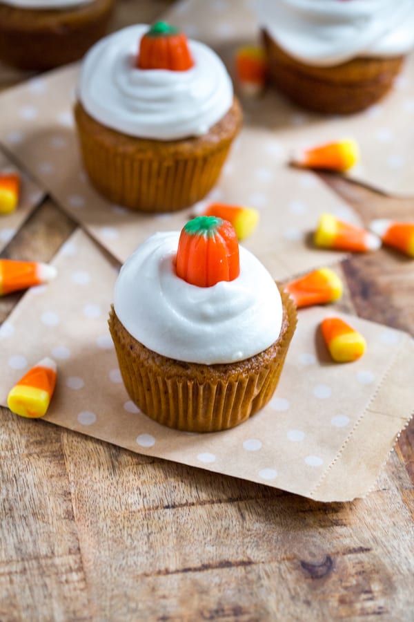 Pumpkin Cupcakes with Cream Cheese Frosting on the Table with Decoration