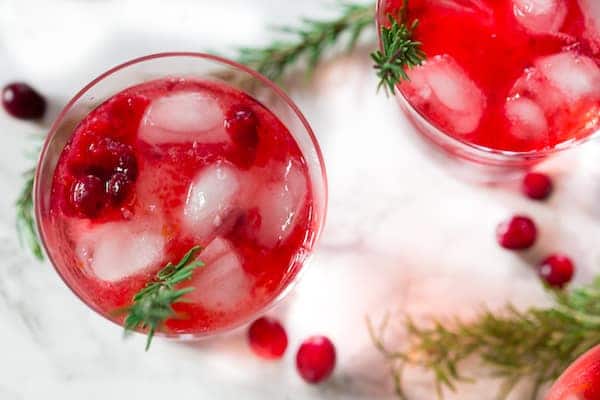 Cranberry Sauce Vodka Smash Colorful Glasses with Cranberry Berries On the Table