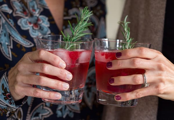 Cranberry Sauce Vodka Smash Cheering with Two Glasses Held in Hands