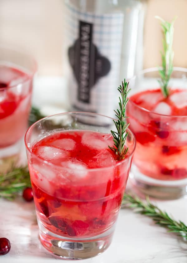 Cranberry Sauce Vodka Smash with Rosemary Decoration and Cranberry Berries around the Glasses