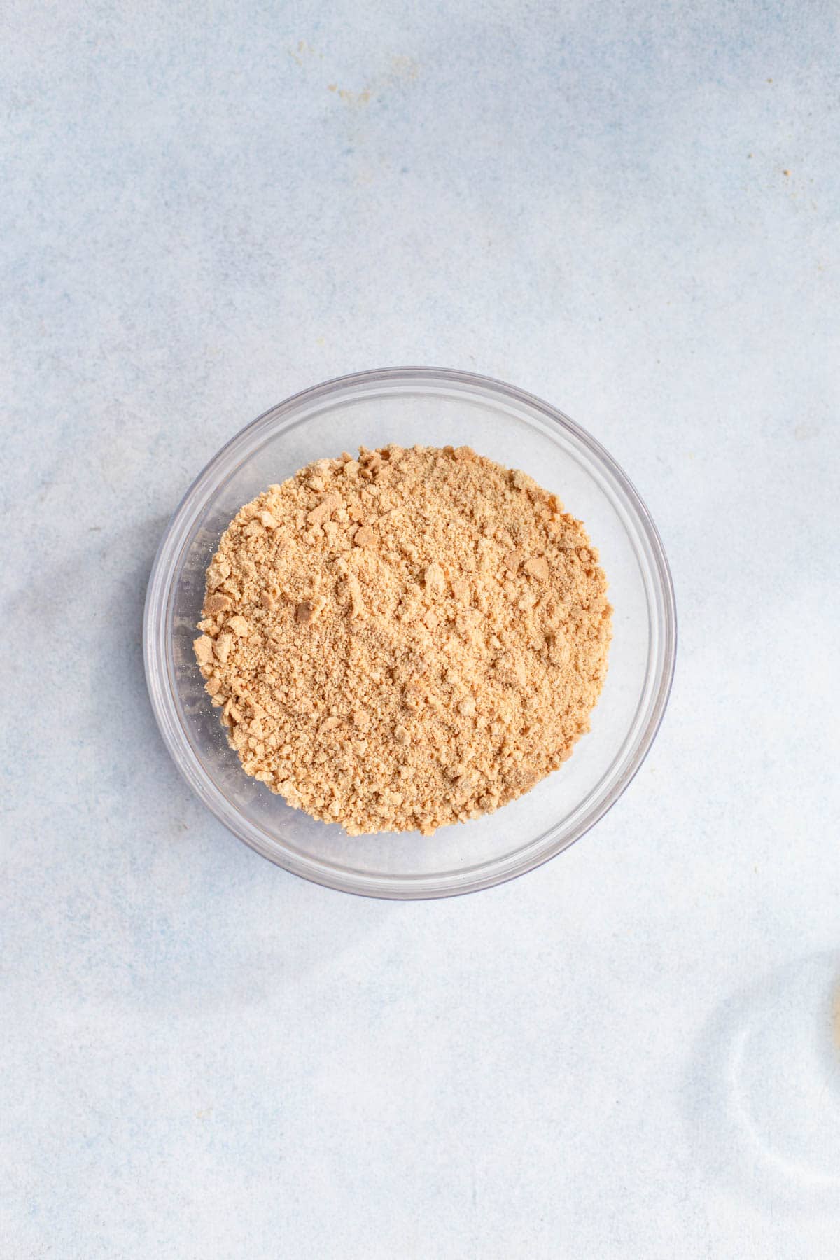 Graham cracker crumbs in a clear glass bowl