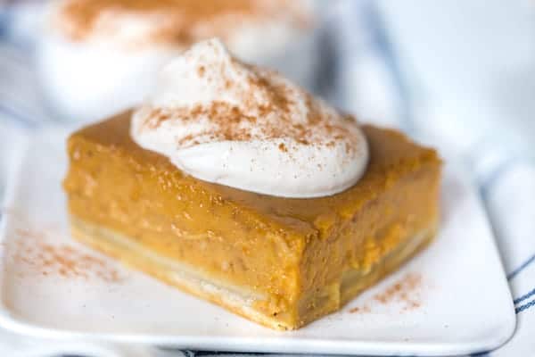 Pumpkin Pie Bars with Maple Whipped Cream Beautifully Served in a Cute Little White Plate