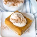 Pumpkin Pie Bars with Maple Whipped Cream on a Towel