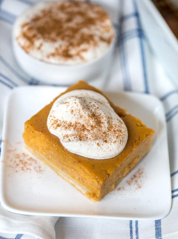 Pumpkin Pie Bars with Maple Whipped Cream on a Towel