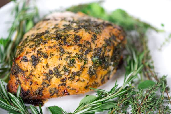 Herb Butter Roasted Turkey Breast Closeup with Herbs on the Plate