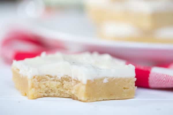 One of the Eggnog Sugar Cookie Bars in focus,and it looks like some has had the first bite already