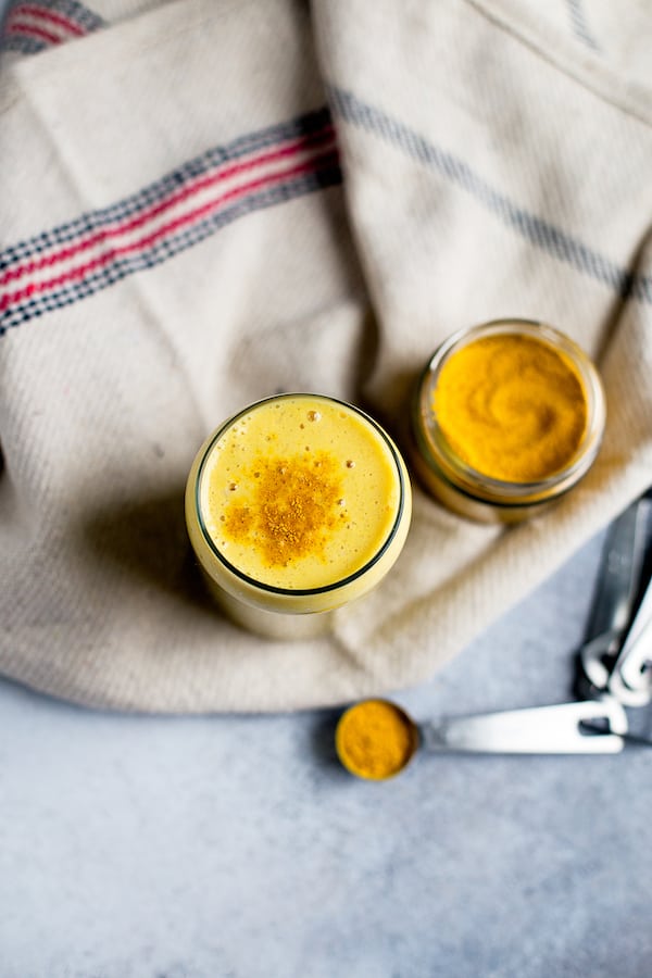 Golden Milk Smoothie Overhead Shot with Measuring Spoons Blurred