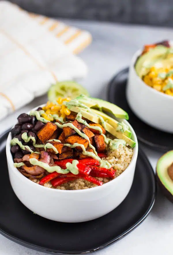 Vegetarian Quinoa Burrito Bowls with Avocado Cream Sauce Beautiful Closeup on the Served Bowl of The Incredible Delicious Meal