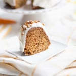 A piece of Carrot Bundt Cake served on a white plate and photographed on a light cloth