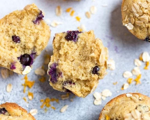 Blueberry Orange Oat Muffins Broken in Halves with Oats Underneath