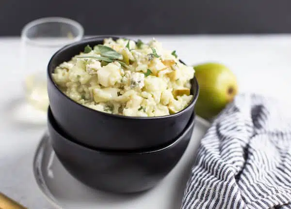 Pear and Gorgonzola Risotto Served with a Striped Cloth Right Next to It