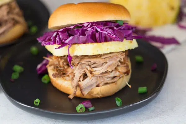 Pressure Cooker Hawaiian Pulled Pork Sandwiches Closeup on One of Them Served in a Small Black Plate
