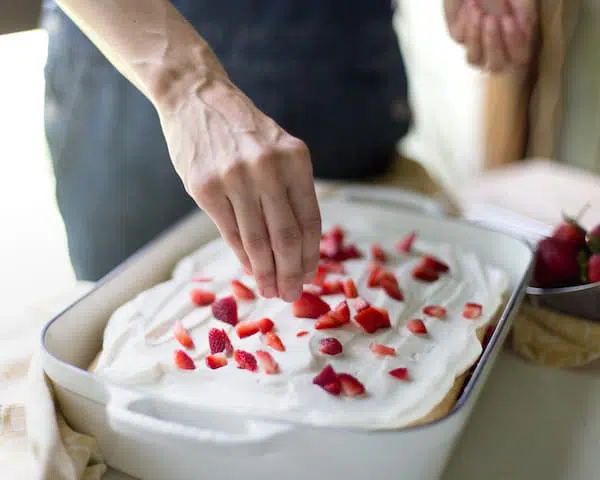 Adding strawberries on top of the shortcake