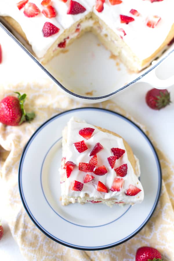 Strawberry Shortcake Cake served on a plate with the rest of the cake left in a tray