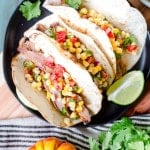Grilled Chipotle Steak Tacos with Grilled Corn Salsa served with greens and lime