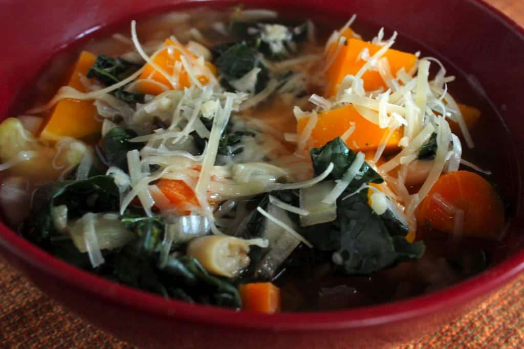 Butternut Squash and Kale Minestrone in a Red Bowl on the Table