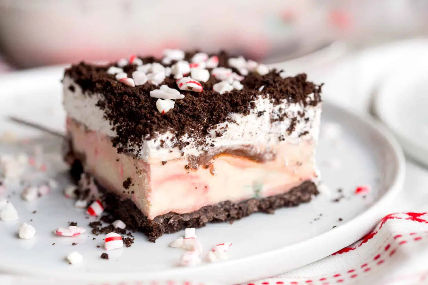 Peppermint Oreo Ice Cream Cake topped with crushed Oreos and candy canes. 
