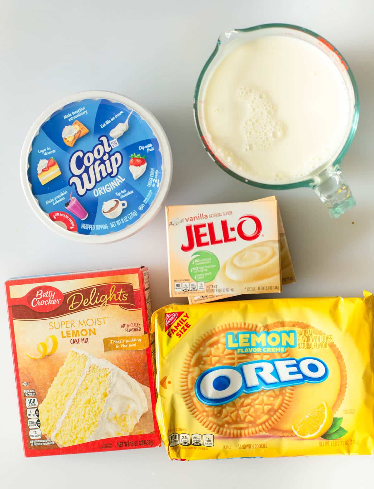 individual packaged ingredients to make lemon poke cake laid out on a counter.