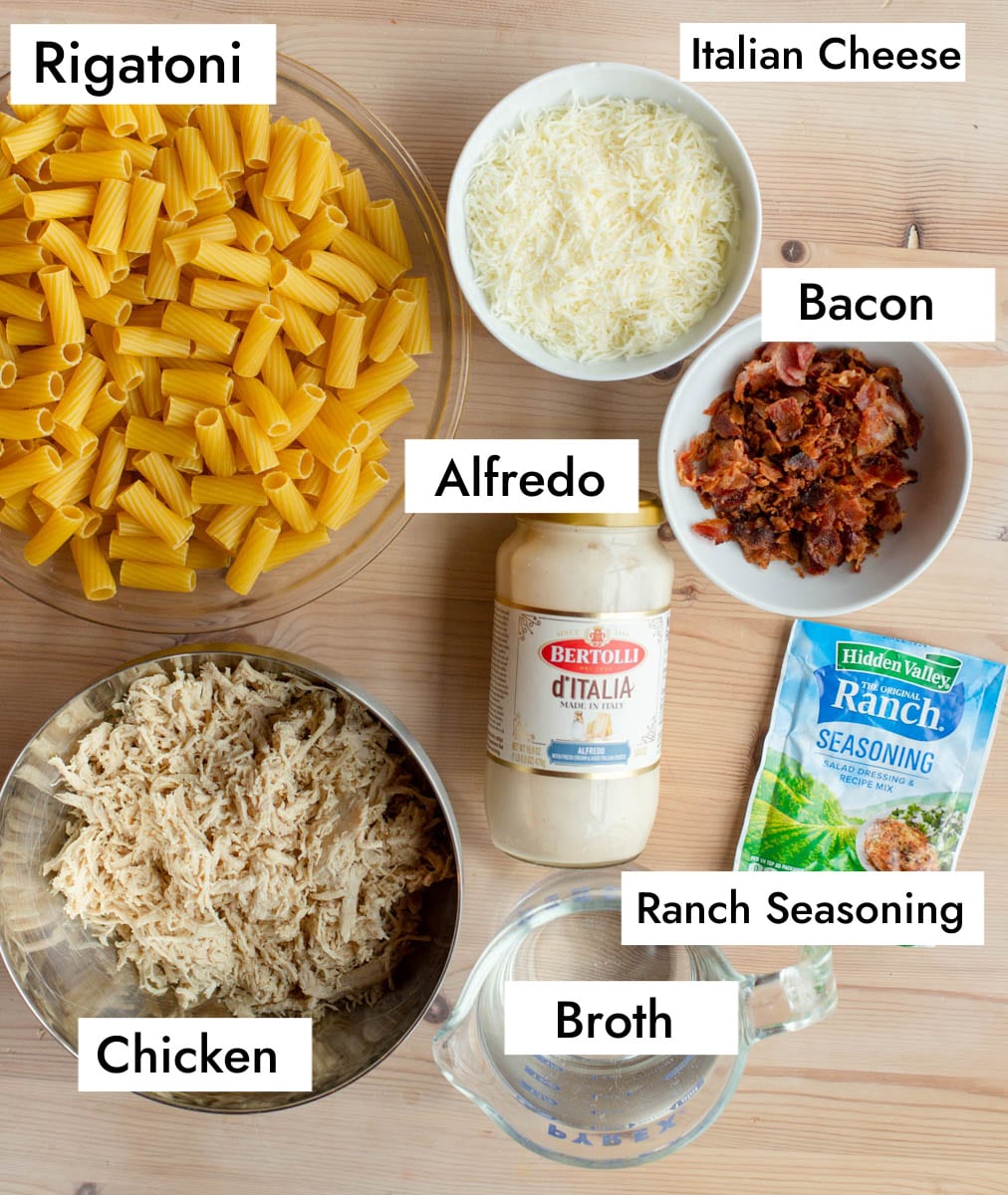 Ingredients in Chicken Bacon Ranch Pasta - rigatoni pasta, Italian cheese, bacon, Alfredo sauce, ranch seasoning, shredded chicken, and broth.