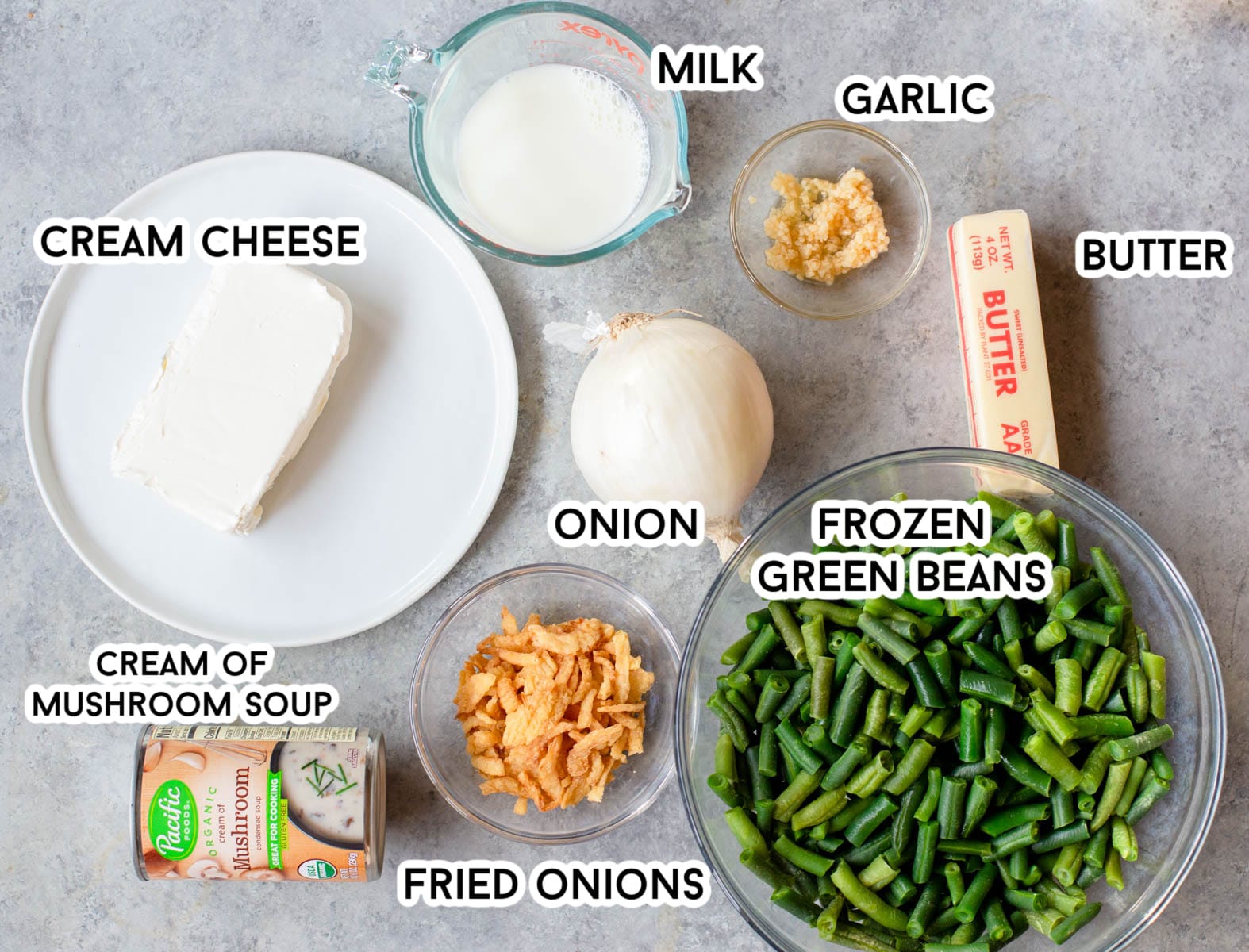 Ingredients in Cream Cheese Green Bean Casserole - cream cheese, milk, garlic, butter, onion, green beans, fried onions, and cream of mushroom soup.