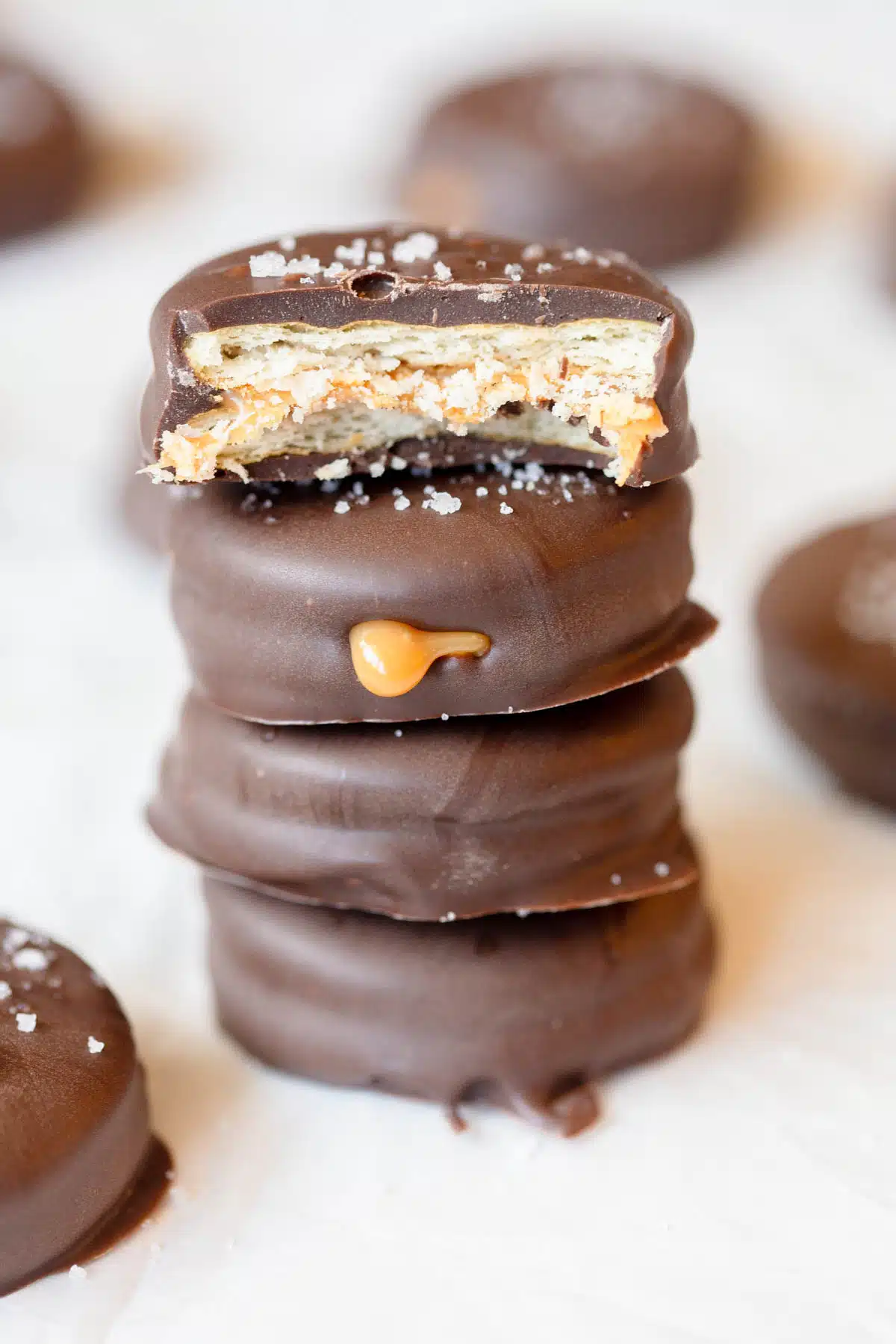 A stack of Ritz Cracker Cookies, with the top one has a bite taken out of it.