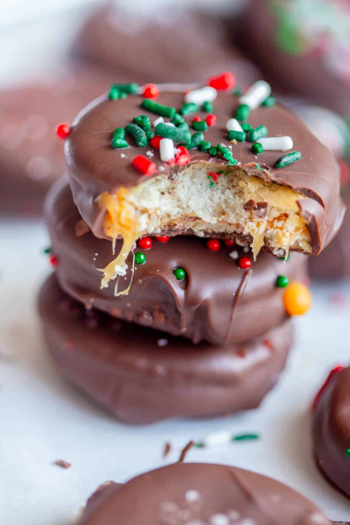 Ritz Cracker Cookies stacked on top of each other, with a bite taken from the top one. 