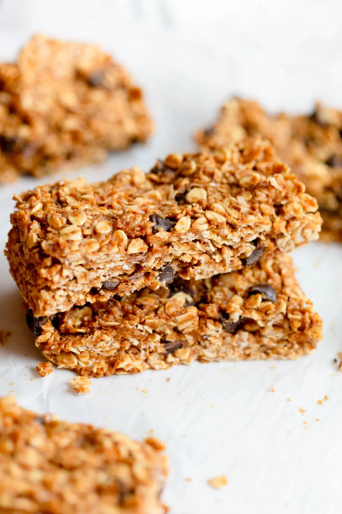 Almond Butter Granola Bars stacked on top of each other with other bars in the background.