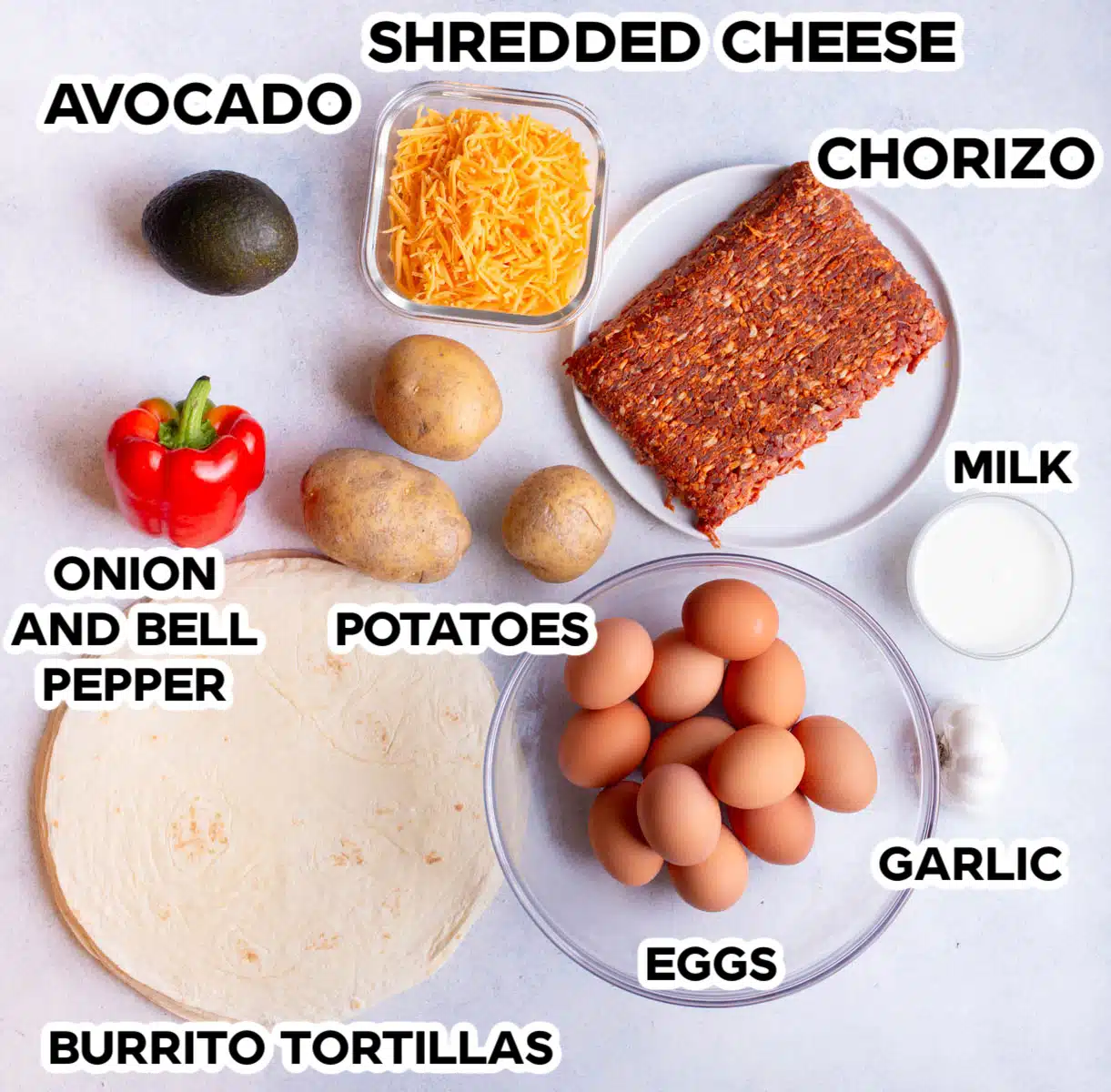 Ingredients in Chorizo Potato Breakfast Burritos lying on a gray background.