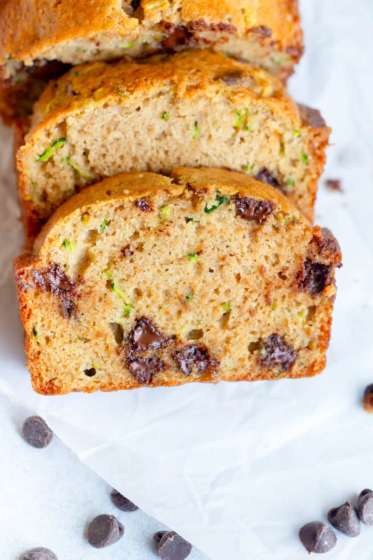 Sliced Chocolate Chip Zucchini Bread on a white background.