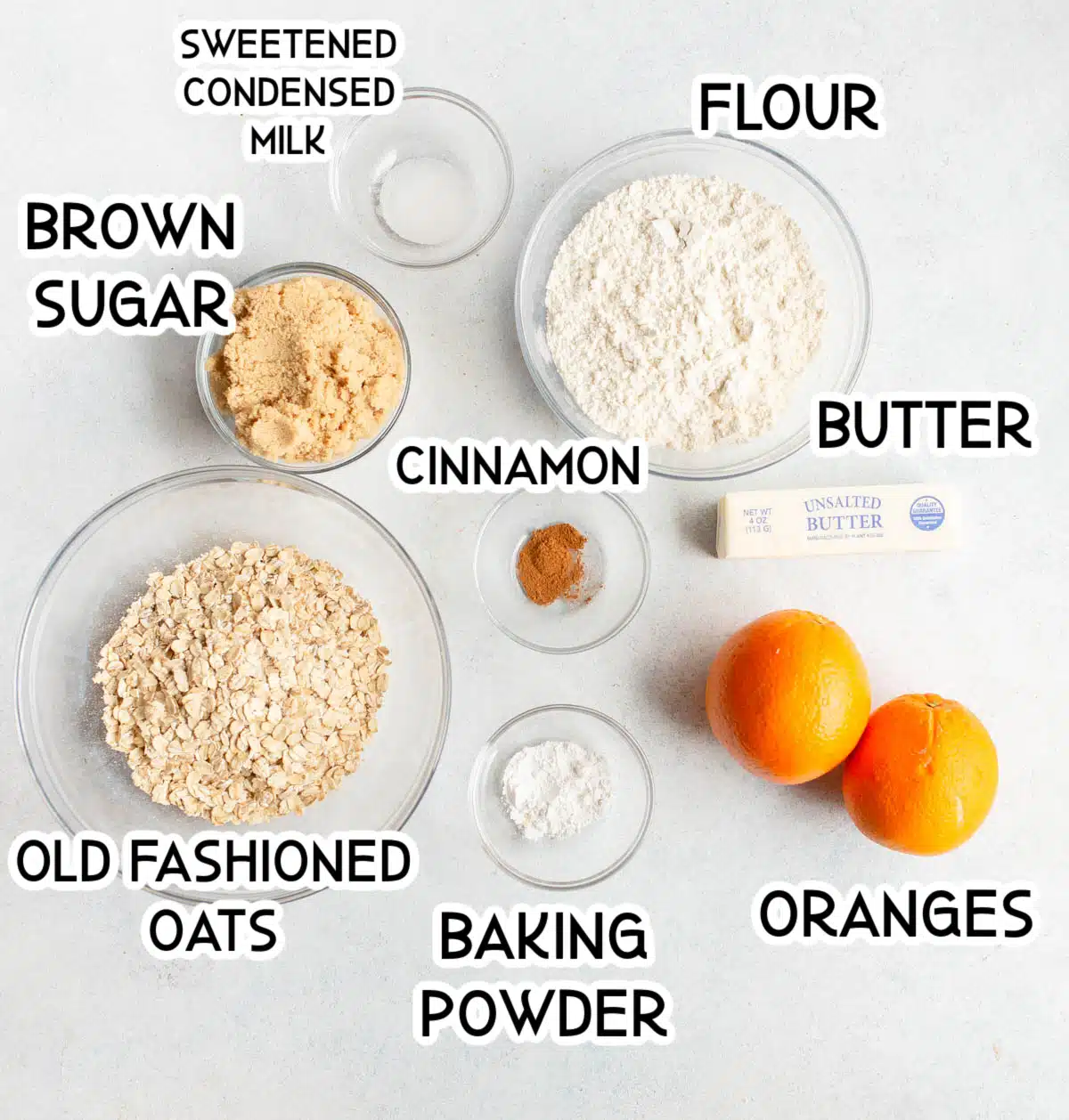 Ingredients in Creamy Orange Bars including sweetened condensed milk, butter, brown sugar, oats, cinnamon, baking powder, and fresh oranges.