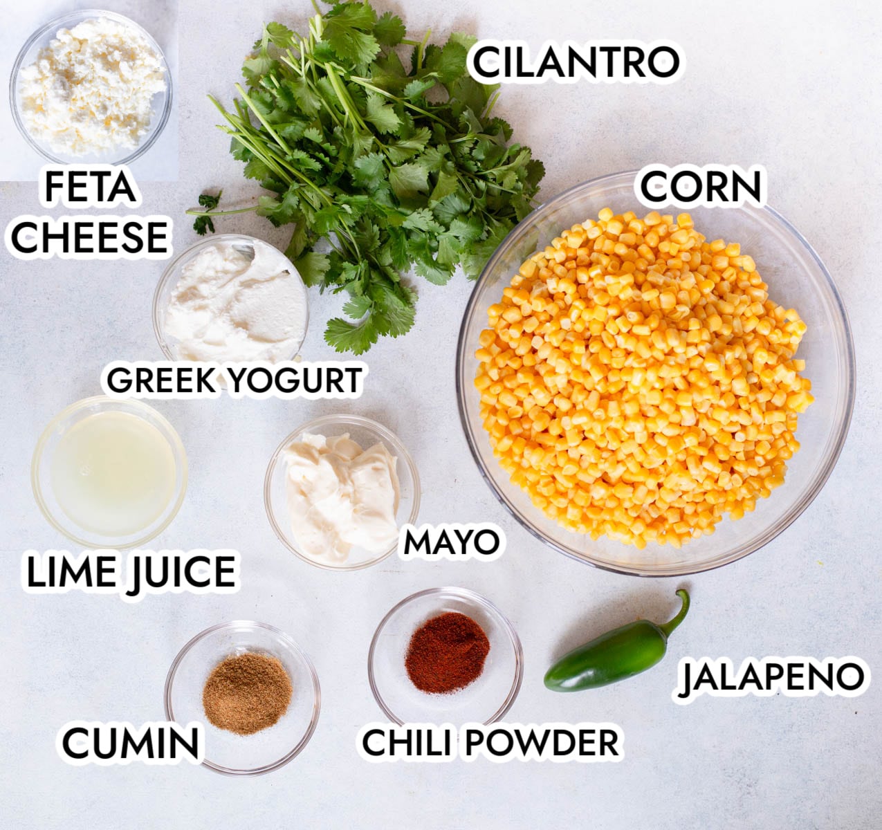 Ingredients in Mexican Street Corn Dip on a gray background.