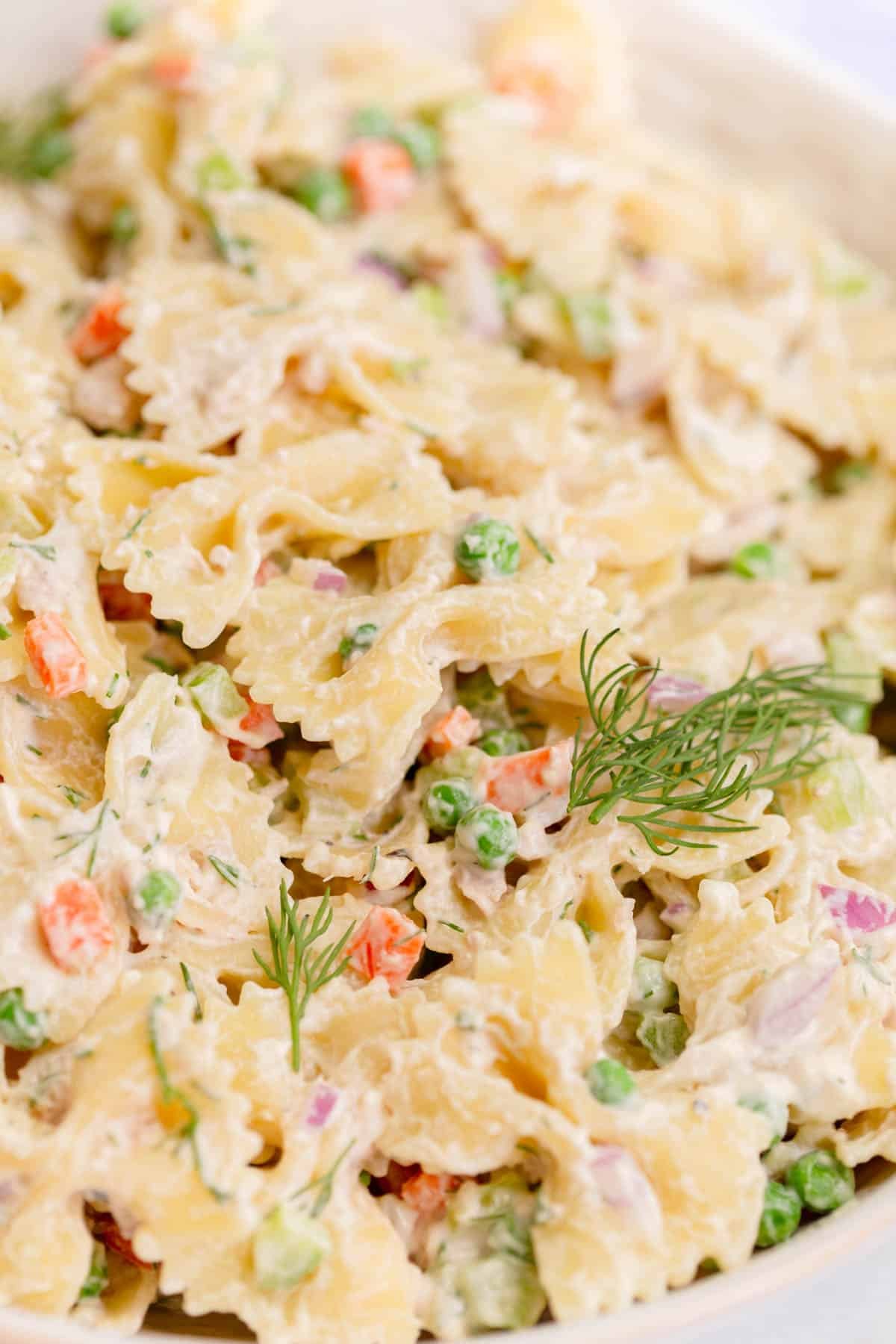 Tuna Pasta Salad with farfalle pasta, peas, carrots, onion, fresh dill, and a creamy dressing. 