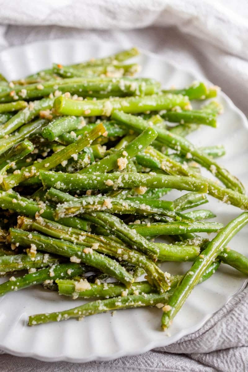 Garlic Parmesan Green Beans on a scalloped salad plate. 