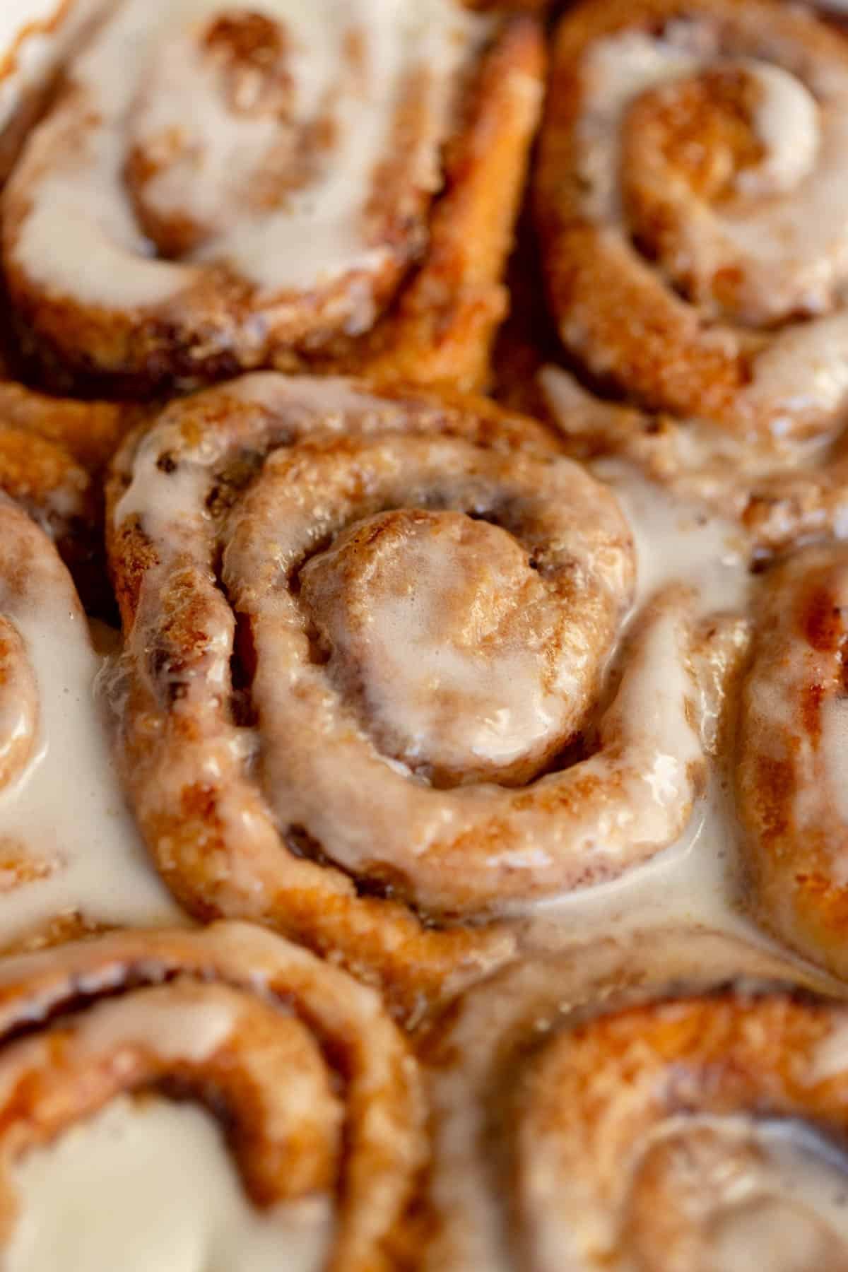 Pumpkin Spice Cinnamon Rolls with frosting on top. 