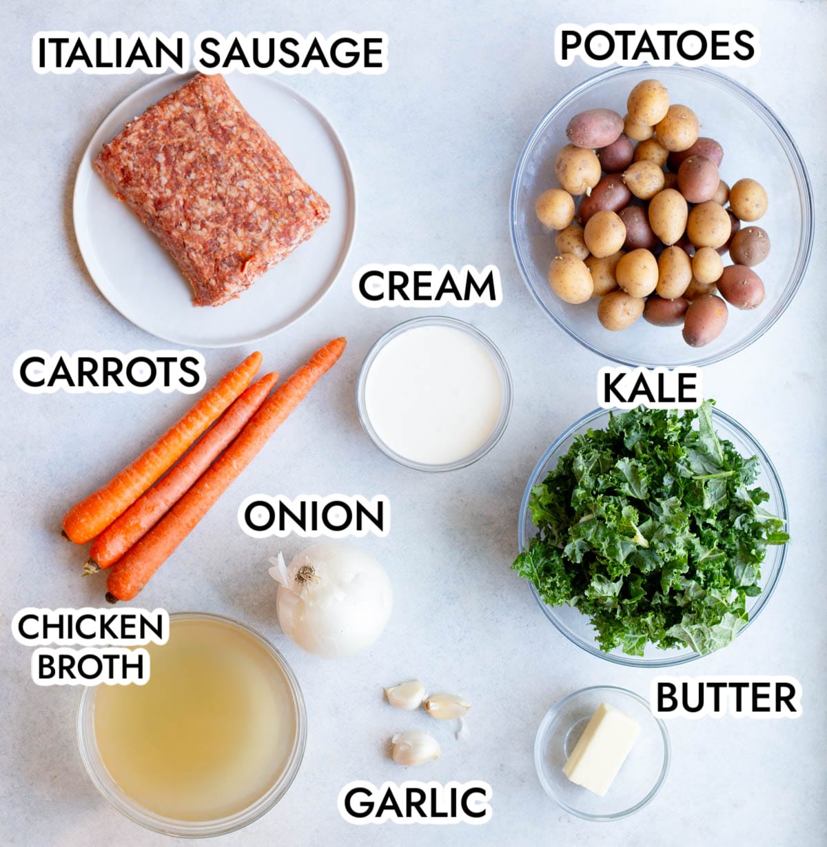 Ingredients in Sausage Kale Potato Soup on a gray background. 