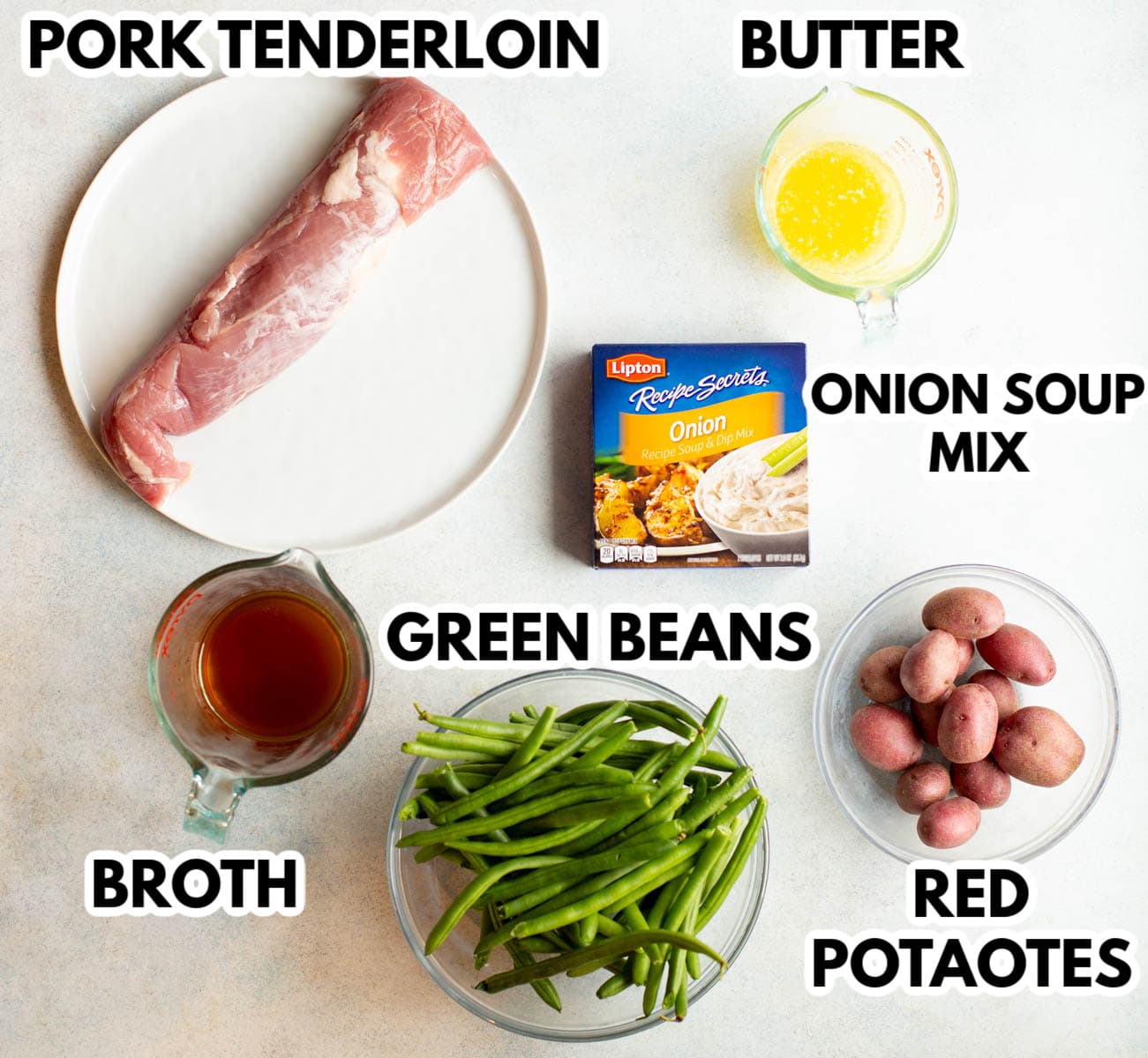 Ingredients in Slow Cooker Pork Tenderloin and Potatoes on a gray background.