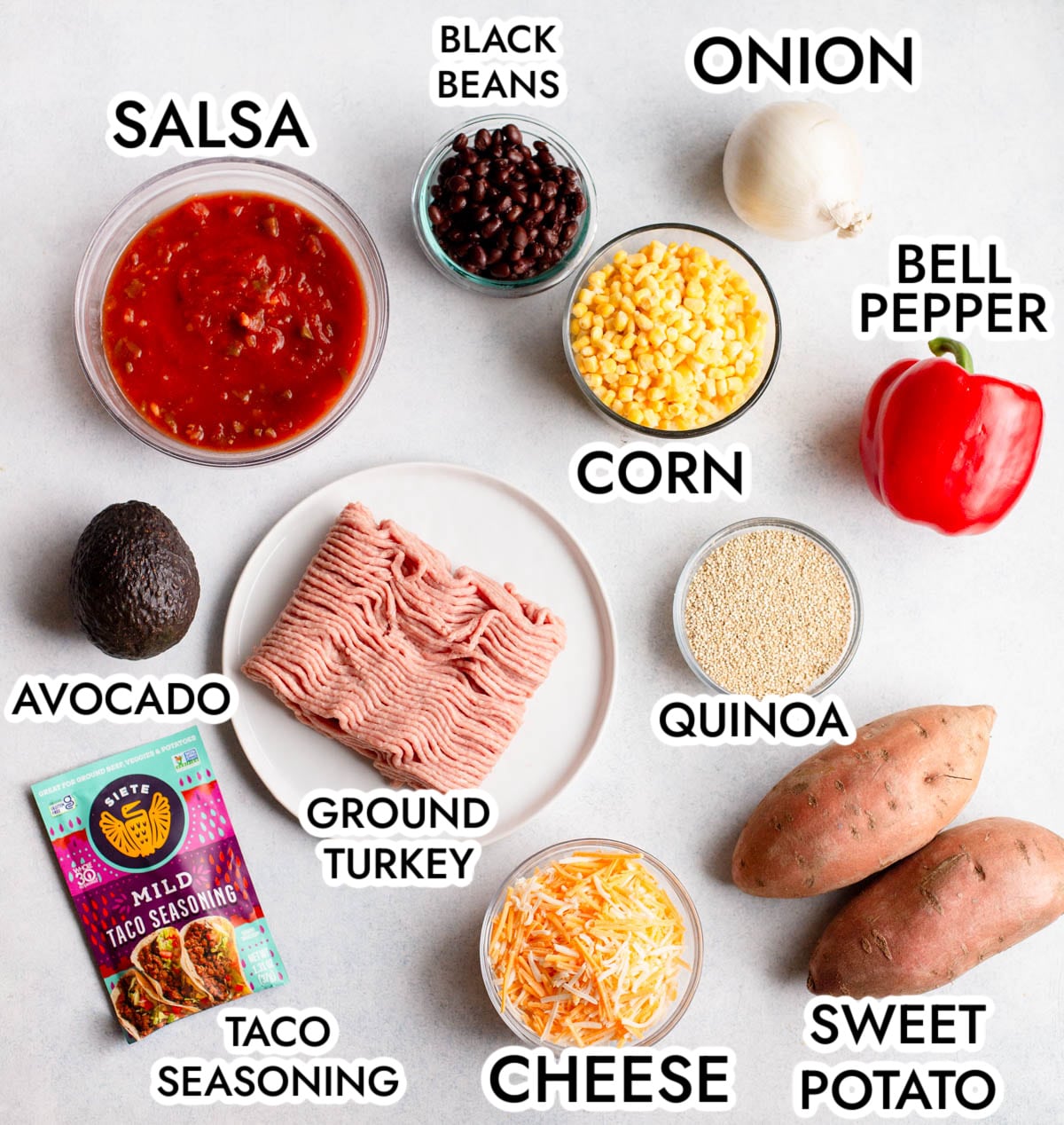 Ingredients in Turkey Taco Quinoa Skillet, labeled, on a gray background. 
