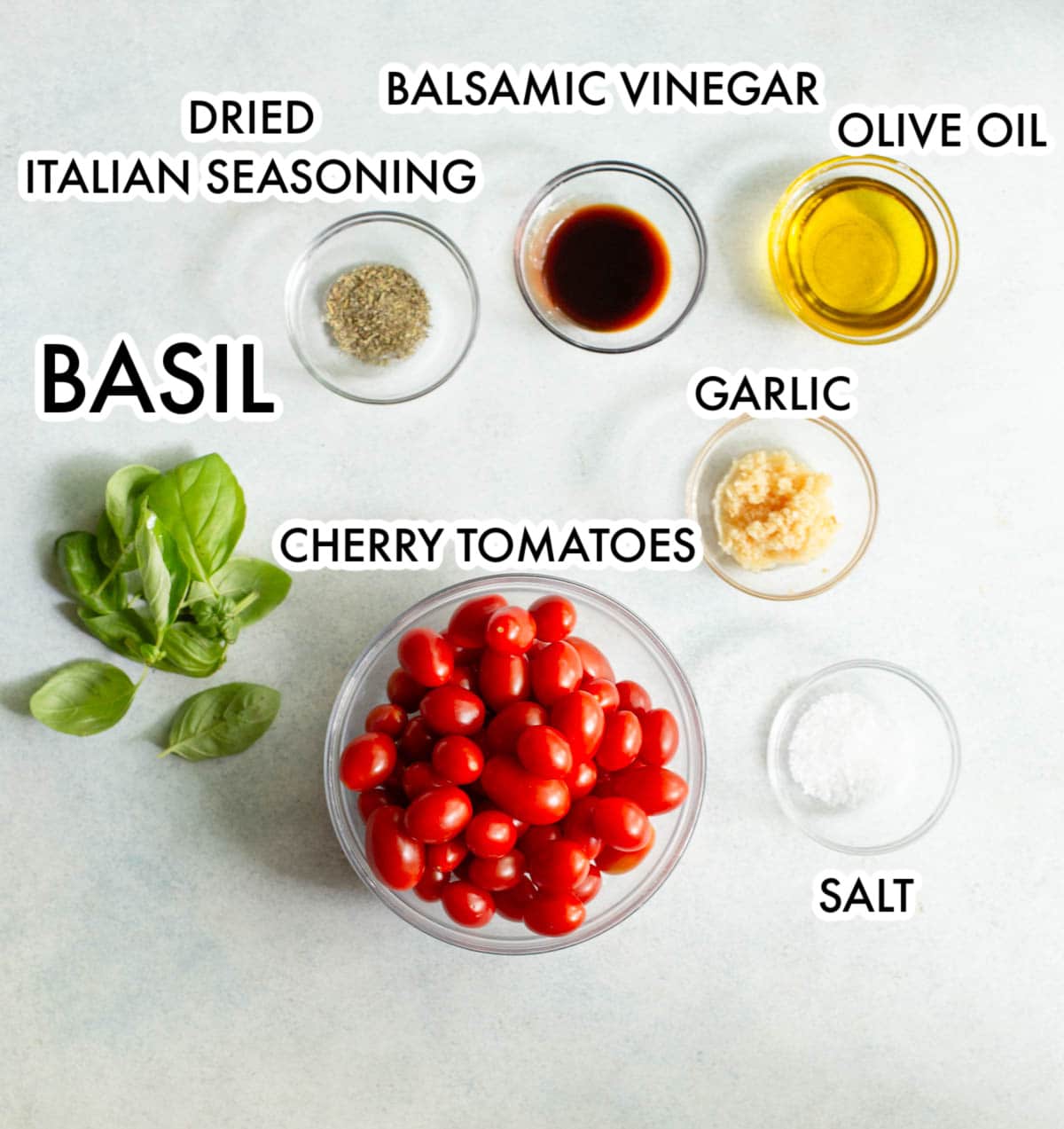 Ingredients in Roasted Tomato Pasta on a gray background.