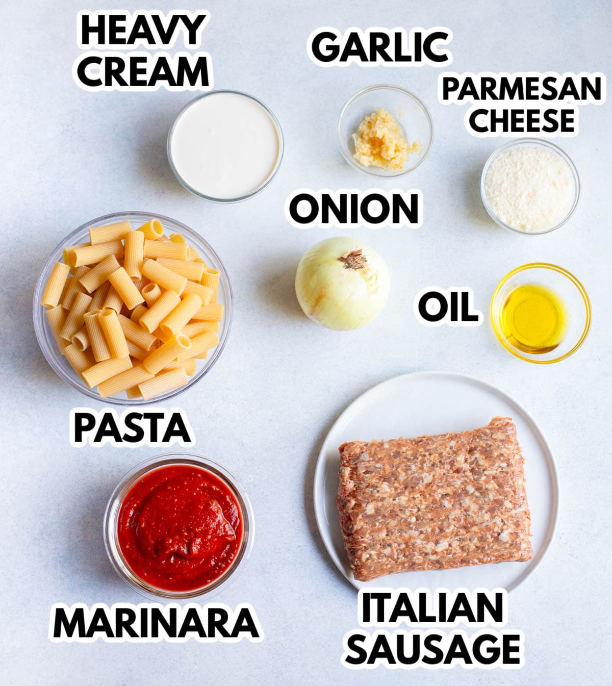 Ingredients in Creamy Italian Sausage Pasta on a gray background. 